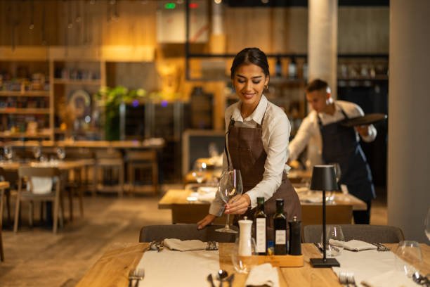 Beautiful waitress working in luxury hotel restaurant.